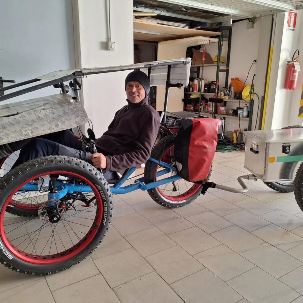 Nicola sitting in his AZUB FAT trike with Aidoo trailer